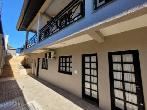 a building with doors and a balcony on it at MD House Express - Petrópolis in Passo Fundo