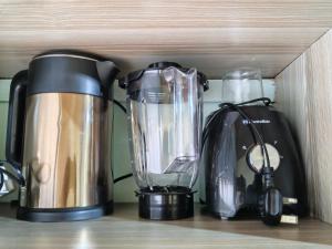 a coffee maker and a blender on a shelf at New Era Homes in Kimana