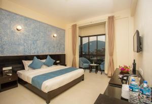Krevet ili kreveti u jedinici u okviru objekta Tuki Resort Pokhara