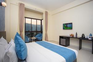 Krevet ili kreveti u jedinici u okviru objekta Tuki Resort Pokhara