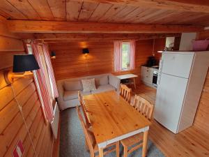 a living room with a table and a refrigerator at Lofoten Budget Hostel in Å