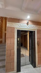 a building with a glass door in the middle at غيوم ابها - شقق مخدومه in Abha