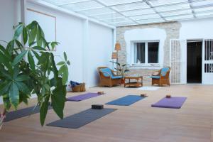 a room with a bunch of yoga mats on the floor at Dhara Wellness Villa in Benirrama +24 photos