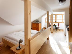 a bedroom with a bed and a desk in a room at Pension Hallberg in Hallstatt