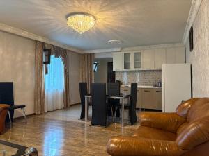 a living room with a couch and a table and a kitchen at Alazani 2015 in Duisi