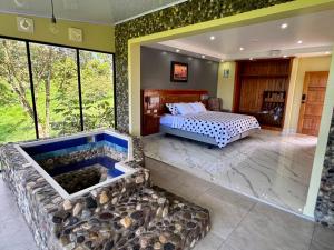 a bedroom with a bed and a tub in a room at Hosteria Arizona in Puyo +45 photos