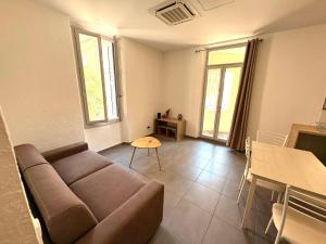 a living room with a couch and a table at Appartements Corte centre in Corte