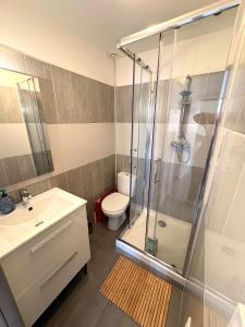 a bathroom with a shower and a toilet and a sink at Appartements Corte centre in Corte +47 photos
