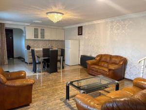 a living room with couches and a table and a kitchen at Alazani 2015 in Duisi +14 photos