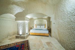 a bedroom with a bed in a building at Chelebi Cave House in Göreme