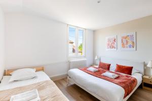 a bedroom with two beds and a window at -New- Colmar, Parking, Comfort, Spacious in Ingersheim +30 photos
