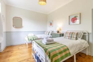 a bedroom with two beds and a mirror at 3 Bed in Northrepps oc-k29801 in Cromer
