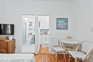 a bedroom with a bed and a table and chairs at Darling Downtown Renovated Historic Condo Walkable in Savannah +28 photos