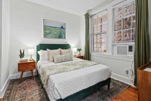 a bedroom with a bed and a window at Darling Downtown Renovated Historic Condo Walkable in Savannah