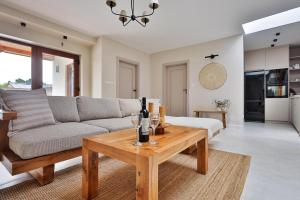 a living room with a couch and a table at BOSzKO HOUSE in Boszkowo +16 photos