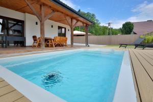 a swimming pool in the backyard of a house at BOSzKO HOUSE in Boszkowo
