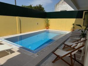 a swimming pool on the side of a house at Capsule Marisol Family Retreat in Corroios