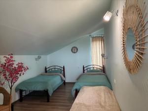 a bedroom with two beds and a mirror on the wall at Garden House in Yerevan