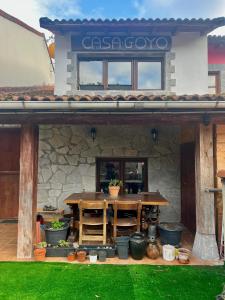 a stone building with a table in front of it at Casa Goyo in Viego