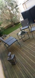 two chairs and a table on a deck at Cas'ArtiGè in Troyes +5 photos