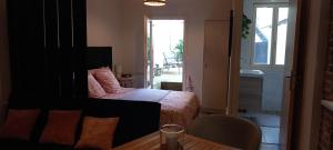 a bedroom with a bed and a table and a window at Cas'ArtiGè in Troyes
