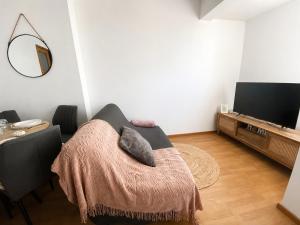 a living room with a chair with pillows on it at La parenthèse in Calais