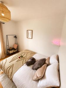 a bedroom with a bed with pillows on it at La parenthèse in Calais