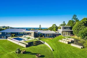 a large house with a large yard with a pool at Byron Retreat in Coopers Shoot