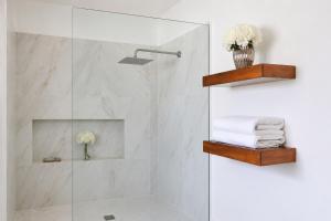 a bathroom with a shower with a glass door at Casa Velamar in Isla Mujeres
