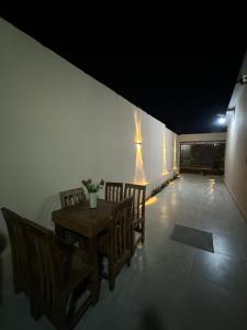 a dining room with a wooden table and chairs at Cintya Maria in Camama +9 photos
