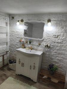 a bathroom with a sink and a mirror at Casa Luna in Călimăneşti +31 photos
