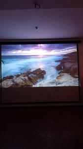 a television screen with a picture of the ocean at Villa Senowin in Anuradhapura