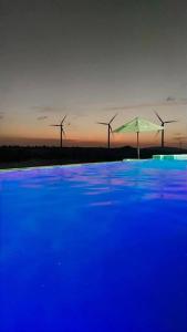a group of windmills in the distance with an umbrella at Villa do Sol - Icaraí de Amontada in Icaraí