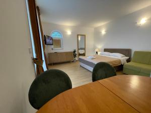a bedroom with a bed and a table and chairs at Guest house Villa Slavica in Sveti Stefan