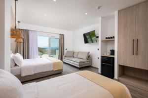 a hotel room with two beds and a couch at Pantheon Hotel in Kefalos +54 photos