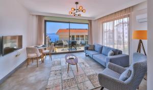 a living room with a blue couch and a table at Hemera Suite in Kaş