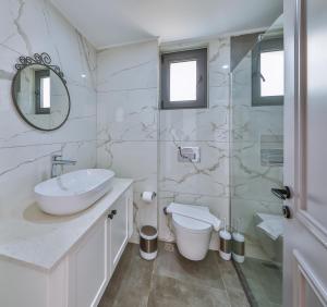 a bathroom with a sink toilet and a mirror at Hemera Suite in Kaş +48 photos