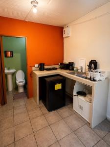 a kitchen with a counter and a toilet in a room at Ballena Oasis Homes & Glamping in Uvita +69 photos