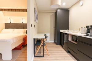 a small bedroom with a bed and a kitchen at Westport Selfcatering Suites in Westport