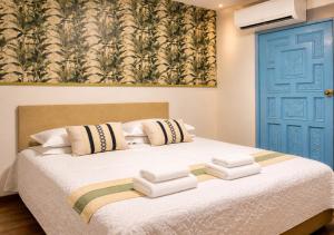 a bedroom with a bed with a blue door at Hotel Kasaya Grand Deluxe in Santa Marta