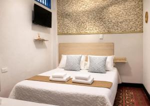a bedroom with a bed with towels on it at Hotel Kasaya Grand Deluxe in Santa Marta
