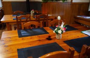 a wooden table with a vase of flowers on it at Posada de Labaien in Beinza-Labayen