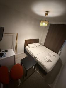 a small bedroom with a bed and a table at Şişli Suites - Room48 in Istanbul