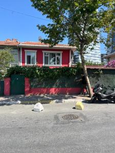 a red house with a motorcycle parked in front of it at Şişli Suites - Room48 in Istanbul +1 photo