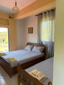 a bedroom with two beds and a window at Moliana Bunec in Himare
