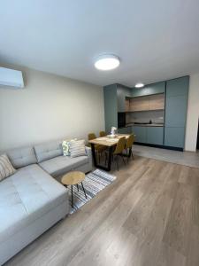 a living room with a white couch and a table at Medoni Summer Hive in Sozopol