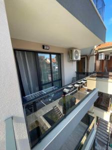 a balcony of a house with a glass railing at Medoni Summer Hive in Sozopol