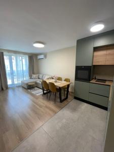 a kitchen and living room with a table and a couch at Medoni Summer Hive in Sozopol