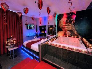 a bedroom with a bed and a tub with a poster at Napoli in relax in Naples