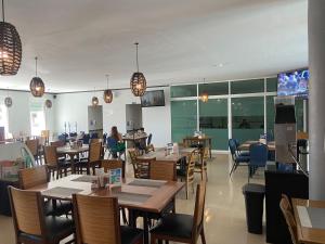 a restaurant with tables and chairs and people sitting at tables at Hotel Maioris La Paz in La Paz
